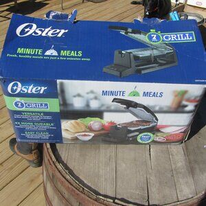 New in box Oster Vertical Dura Ceramic grill provides easy clean meals in minute